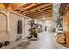Unfinished basement featuring exposed beams, white painted brick, a punching bag, spin bike, and ample storage space at 10802 Giselle Way, Fishers, IN 46040