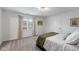 Carpeted bedroom featuring light-blocking curtains, a window, and base-molding at 10802 Giselle Way, Fishers, IN 46040