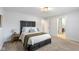 Carpeted primary bedroom featuring natural light, an end table, and a large doorway at 10802 Giselle Way, Fishers, IN 46040