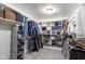 Organized walk-in closet with custom shelving and hanging rods to keep all of your wardrobe neat at 10802 Giselle Way, Fishers, IN 46040