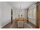 Formal dining room boasts a live edge wood table and statement chandelier at 10802 Giselle Way, Fishers, IN 46040