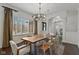 Bright dining room featuring a modern chandelier and a large live edge table at 10802 Giselle Way, Fishers, IN 46040