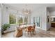 Bright dining room with large windows and unique chandelier at 10802 Giselle Way, Fishers, IN 46040