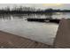 View of a partially submerged dock on a river with murky water, suggesting a possible flooding event at 10802 Giselle Way, Fishers, IN 46040