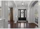 Elegant foyer featuring dark wood flooring, white pillars, and a stylish front door with sidelights at 10802 Giselle Way, Fishers, IN 46040