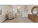 Hallway entrance with decorative pillars, light walls, and decorative mirror leads into the bathroom at 10802 Giselle Way, Fishers, IN 46040