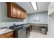 Well-lit laundry room with front loading washer/dryer, storage cabinets, and countertop at 10802 Giselle Way, Fishers, IN 46040