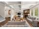 Comfortable living room with stone fireplace, coffered ceiling, and custom built-in shelving at 10802 Giselle Way, Fishers, IN 46040