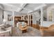 Open-concept living area with hardwood floors, stylish furniture, and views of the kitchen and staircase at 10802 Giselle Way, Fishers, IN 46040