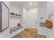 Mudroom features built-in bench with storage, coat hooks, and durable tiled flooring, perfect for organization at 10802 Giselle Way, Fishers, IN 46040
