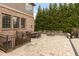Backyard patio with a stone fireplace, dining table and chairs, stone pavers, and exterior basement entrance at 10802 Giselle Way, Fishers, IN 46040