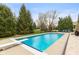Backyard featuring an in-ground pool, diving board, and a beautiful lawn with mature trees and landscaping at 10802 Giselle Way, Fishers, IN 46040