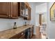 Charming wet bar with granite counters, wood cabinetry and wine storage at 10802 Giselle Way, Fishers, IN 46040