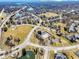 Aerial view of a neighborhood featuring a pool, basketball court, green spaces, ponds and well-maintained landscaping at 12396 Dellfield W Blvd, Carmel, IN 46033