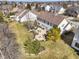 Aerial view of a backyard with a patio, fire pit, green lawn and mature trees at 12396 Dellfield W Blvd, Carmel, IN 46033