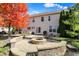 Inviting backyard with a custom stone fire pit, patio, and mature trees providing privacy at 12396 Dellfield W Blvd, Carmel, IN 46033