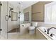 Bright bathroom features a glass shower stall, bathtub, and modern fixtures at 12396 Dellfield W Blvd, Carmel, IN 46033