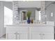 Elegant bathroom featuring a double sink vanity, marble countertops, decorative mirrors, and mosaic tile accents at 12396 Dellfield W Blvd, Carmel, IN 46033
