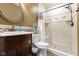 Well-maintained bathroom features a tiled shower and a dark wood vanity and a decorative mirror at 12396 Dellfield W Blvd, Carmel, IN 46033