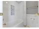 Clean bathroom with a white bathtub, shower with mosaic accents, and brushed gold hardware at 12396 Dellfield W Blvd, Carmel, IN 46033