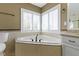 Bright bathroom with a corner tub, ceramic tile, and neutral colored walls at 12396 Dellfield W Blvd, Carmel, IN 46033