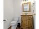 Charming powder room boasts a stylish vanity with decorative mirror and elegant fixtures at 12396 Dellfield W Blvd, Carmel, IN 46033