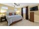 Comfortable bedroom featuring a ceiling fan, and a flat screen television above a dresser at 12396 Dellfield W Blvd, Carmel, IN 46033