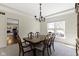 Bright dining room with a traditional chandelier, seating for six, and large windows at 12396 Dellfield W Blvd, Carmel, IN 46033