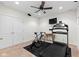 A personal gym featuring a treadmill, stationary bike, ceiling fan, and a wall-mounted television at 12396 Dellfield W Blvd, Carmel, IN 46033