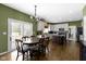 Gourmet kitchen with custom cabinets, island with seating, and adjacent dining area bathed in natural light at 12396 Dellfield W Blvd, Carmel, IN 46033