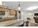 A full kitchenette features granite countertops, stainless steel appliances, and warm, wood-toned cabinetry at 12396 Dellfield W Blvd, Carmel, IN 46033