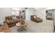 Inviting living room with cozy leather seating, coffee table, and an open layout connecting to the kitchen at 12396 Dellfield W Blvd, Carmel, IN 46033