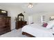 Bedroom boasts a vaulted ceiling, ceiling fan, and a dark wood dresser at 12396 Dellfield W Blvd, Carmel, IN 46033
