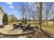 An outdoor patio features comfortable seating, and mature trees, perfect for entertaining at 12396 Dellfield W Blvd, Carmel, IN 46033