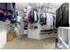Spacious walk-in closet features built-in shelving and ample storage space for clothes, shoes and storage containers at 12396 Dellfield W Blvd, Carmel, IN 46033