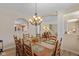 Bright and spacious dining room featuring hardwood floors, a view of the staircase, and modern chandelier at 13504 E 131St St, Fishers, IN 46037