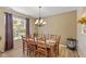 Spacious dining room featuring a large wood table with seating for ten and abundant natural light at 13504 E 131St St, Fishers, IN 46037