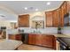 Updated kitchen features wood cabinets, stainless steel appliances, and a tiled backsplash at 13504 E 131St St, Fishers, IN 46037