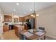 Charming eat-in kitchen area that includes a breakfast nook, wooden cabinets, and modern black appliances at 13504 E 131St St, Fishers, IN 46037