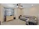 Comfortable living room boasts a ceiling fan, lots of natural light, and neutral decor at 13504 E 131St St, Fishers, IN 46037
