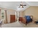 Spacious bedroom features a sleigh bed, ceiling fan, vaulted ceilings, and two windows at 13504 E 131St St, Fishers, IN 46037