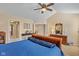 Large primary bedroom features a ceiling fan and access to a walk-in closet and bathroom at 13504 E 131St St, Fishers, IN 46037