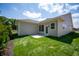 The backyard features a well-maintained lawn, newly planted shrubs, and a neutral-colored home exterior at 14383 Coyote Ridge Dr, Noblesville, IN 46060