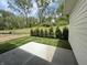Well-maintained backyard with lush green grass, trimmed shrubs, and a concrete patio at 14383 Coyote Ridge Dr, Noblesville, IN 46060