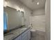 Bright bathroom with granite countertop vanity, large mirror, tile floors and a shower-tub combination at 14383 Coyote Ridge Dr, Noblesville, IN 46060
