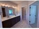 Bathroom featuring double vanity, quartz countertops, and a large mirror and entry to water closet at 14383 Coyote Ridge Dr, Noblesville, IN 46060