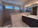 Modern bathroom featuring a double vanity with quartz countertops and large tiled walk-in shower with glass panel at 14383 Coyote Ridge Dr, Noblesville, IN 46060