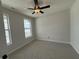 Serene bedroom with neutral walls, carpet, trim, and two windows at 14383 Coyote Ridge Dr, Noblesville, IN 46060