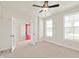 Neutral bedroom with a ceiling fan, plush carpet, and french doors for natural light at 14383 Coyote Ridge Dr, Noblesville, IN 46060