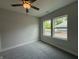 Cozy bedroom featuring two windows that bring in natural light, carpet, and a ceiling fan at 14383 Coyote Ridge Dr, Noblesville, IN 46060